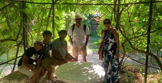 Happy family clients enjoying the secret gardens of Venice, Italy