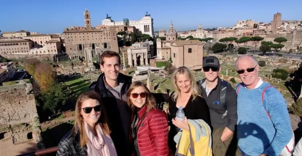 Happy clients smiling while enjoying the beauty of ancient Rome, Italy