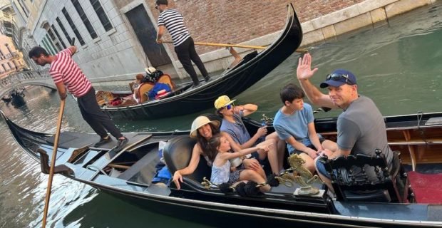 family clients enjoying a private gondola and glide through the canals of Venice, Italy